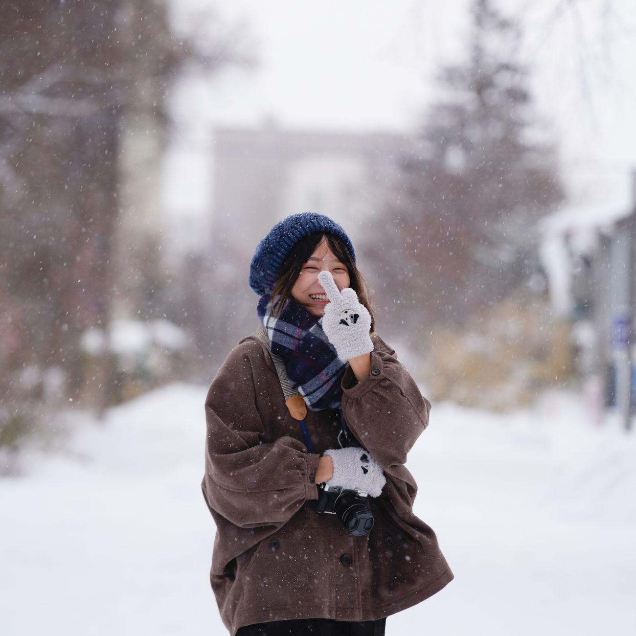 Person wearing warm gloves in winter outdoor setting